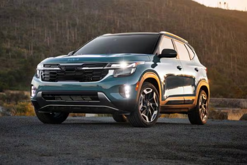 A teal Kia Seltos SUV parked outdoors, showcasing its rugged design.
